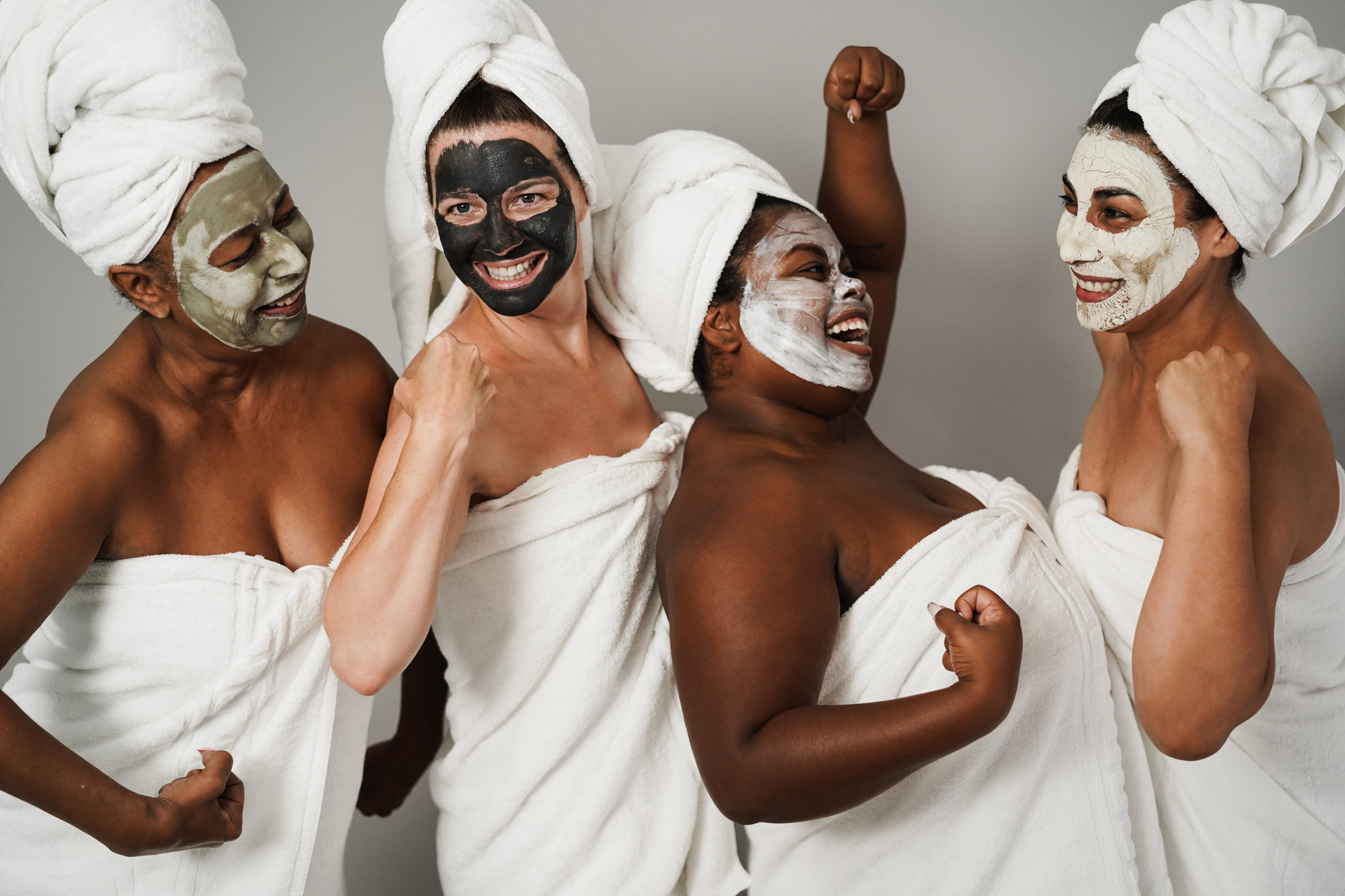 Multigenerational women having fun wearing face beauty mask